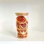 Glass bamboo storage jar filled with dried oranges, perfect for pantry or fridge organizing.