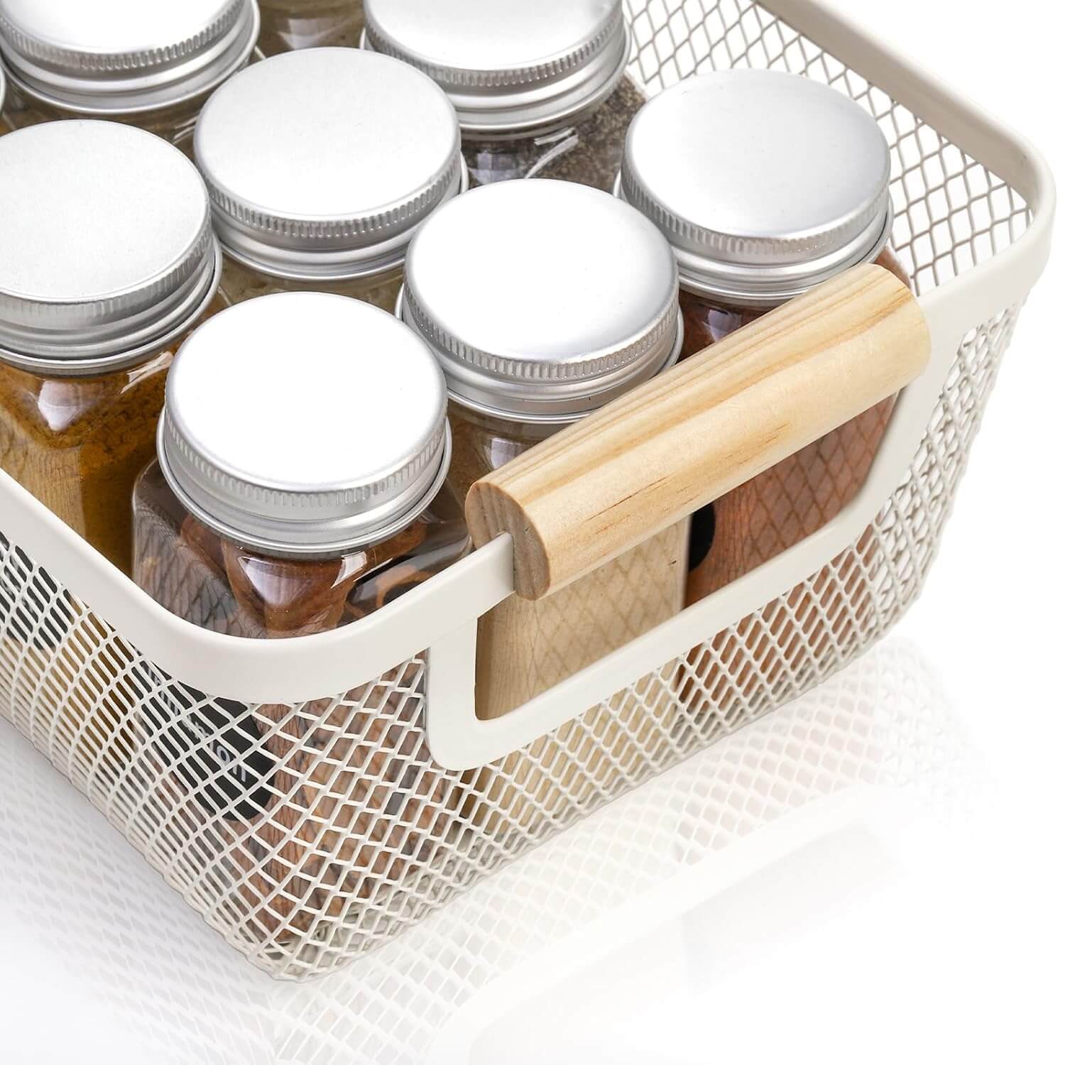 White mesh storage basket with wooden handles holding pantry jars for kitchen organization.