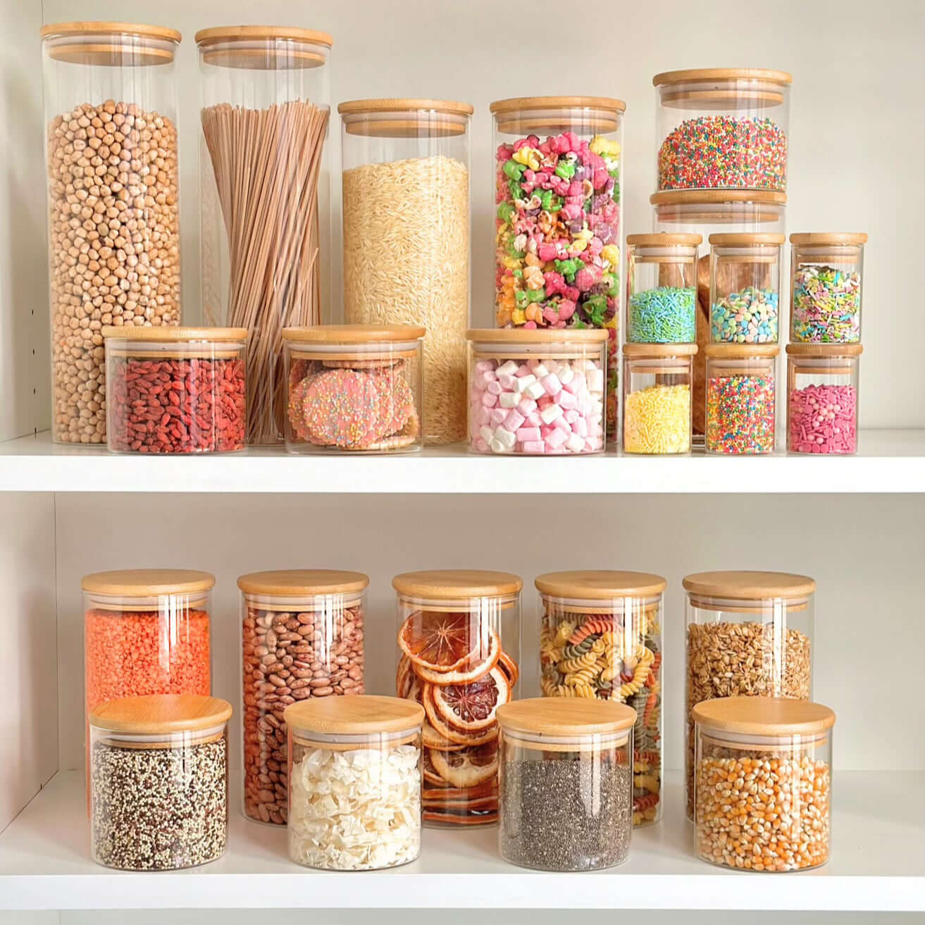 Bamboo glass pantry jars organizing colorful snacks on a shelf, space-saving storage solution.