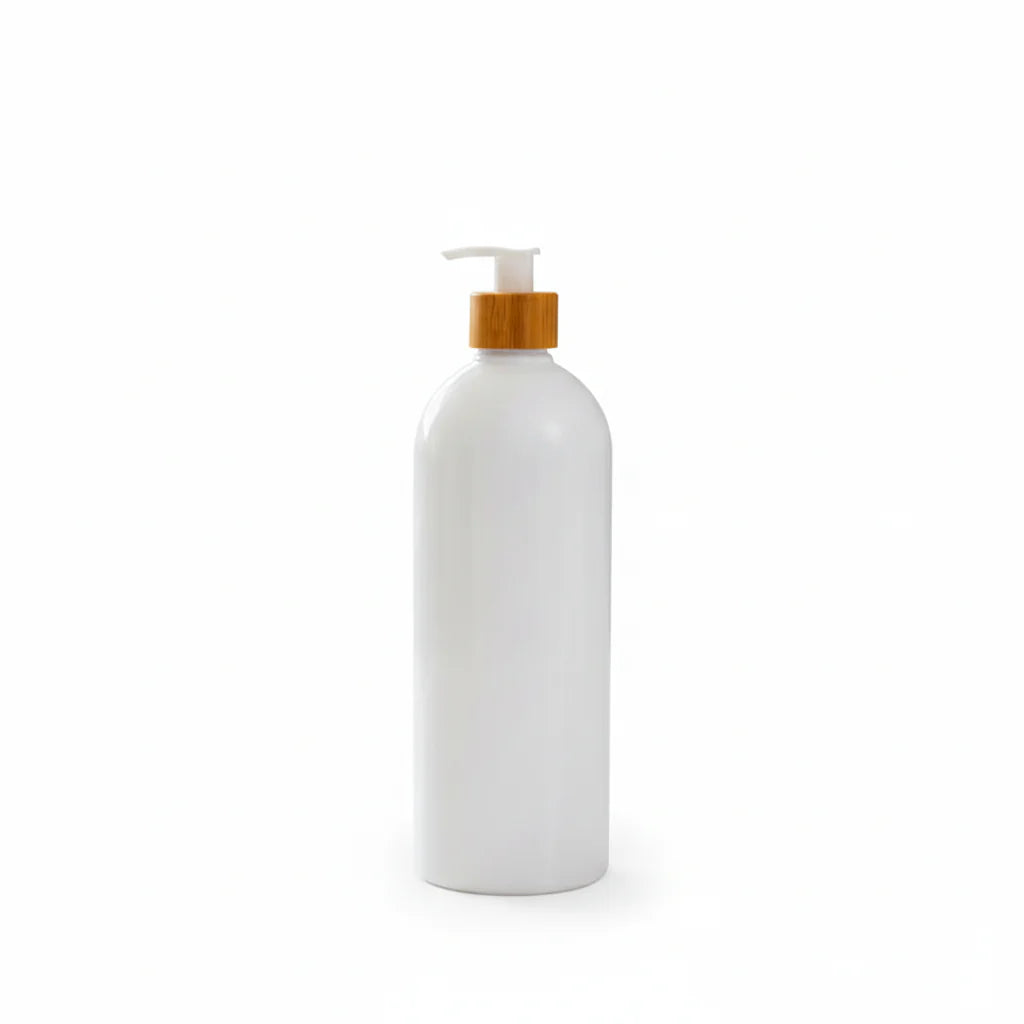 White bottle with a wooden pump on a bathroom counter with plants in the background